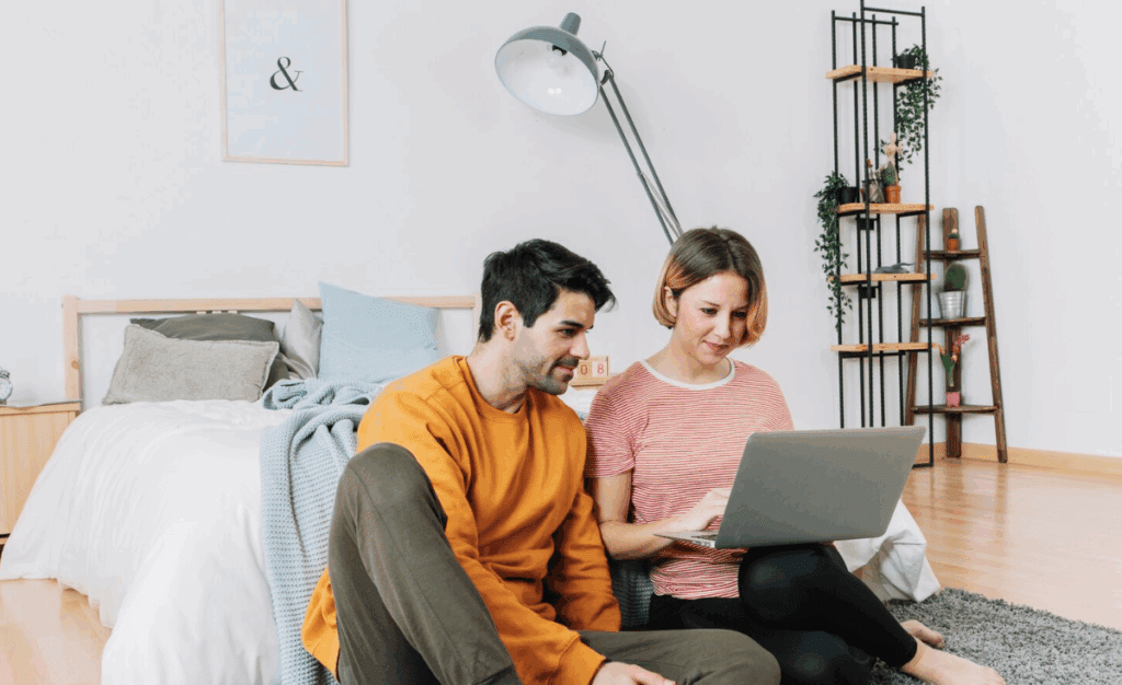 A couple reviewing mortgage rates on a laptop.