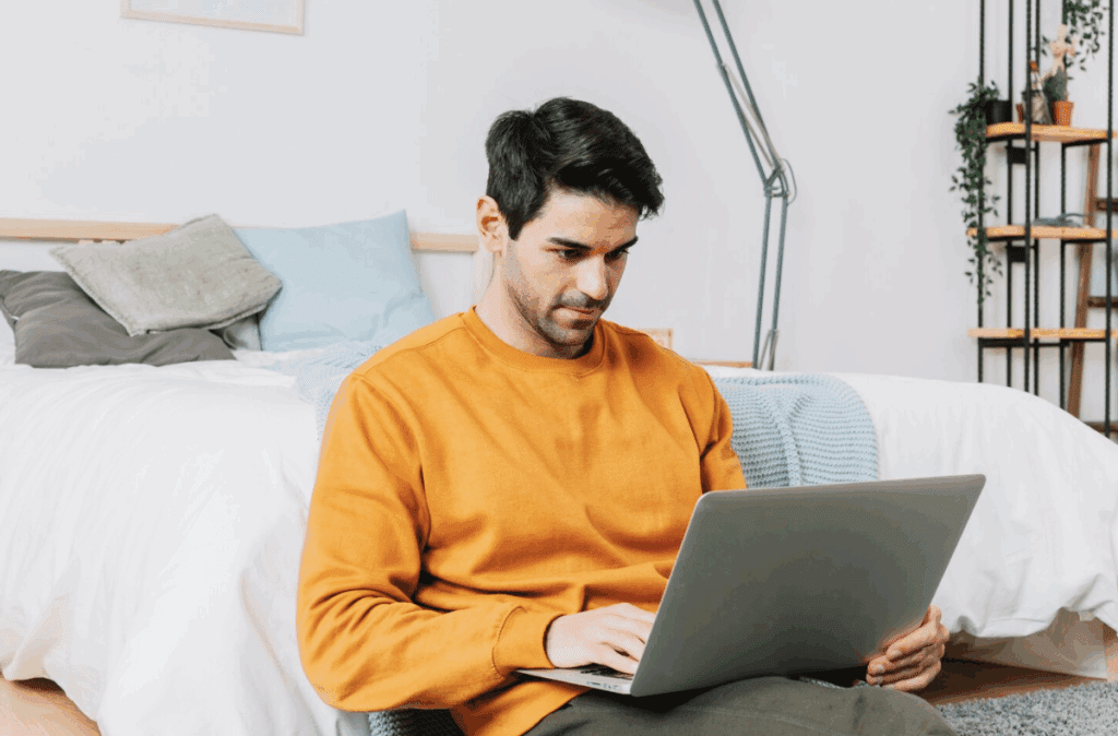 A self-employed borrower researching loan options on a laptop.