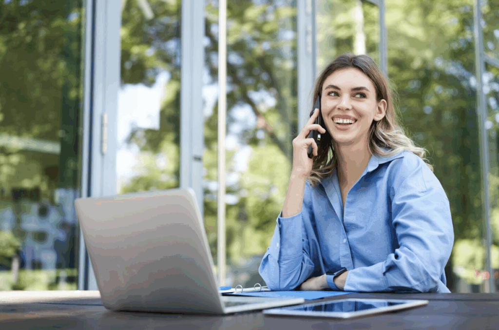 Woman celebrating success while looking at tablet.